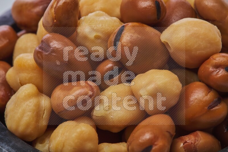 Close up shot of cooked fava beans (foul) & chickpeas on white background