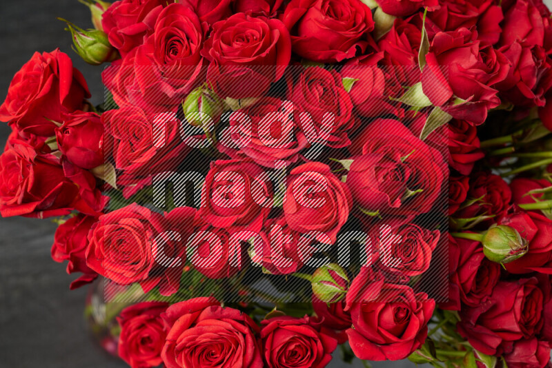 A luxurious bouquet of red roses on black marble background