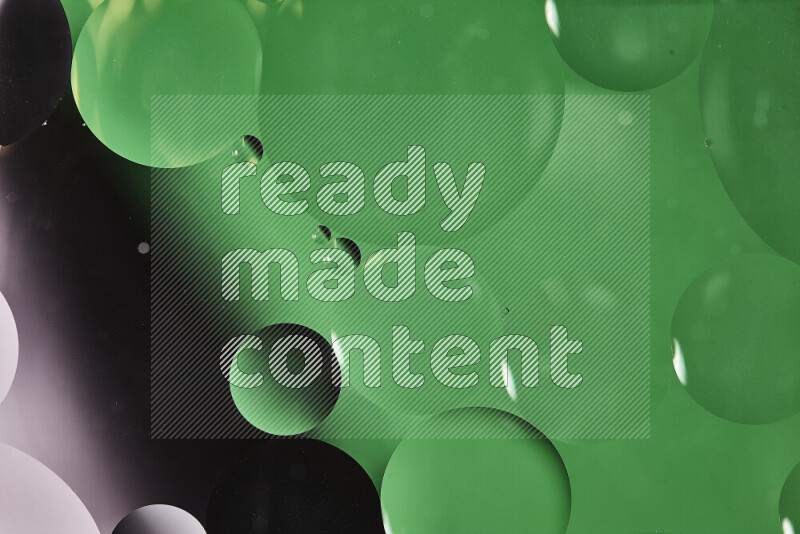 Close-ups of abstract oil bubbles on water surface in shades of white and green