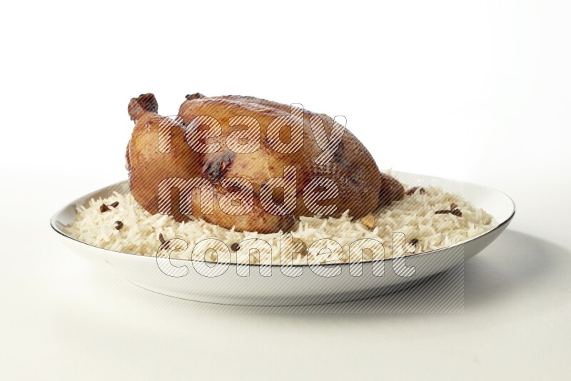 white  basmati Rice with  whole roasted chicken  on a white plate with a silver rim direct  on white background