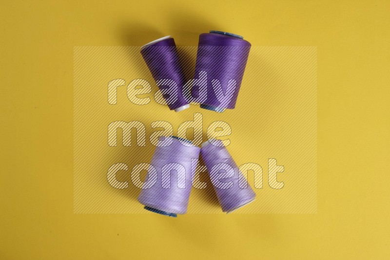 Purple sewing supplies on yellow background