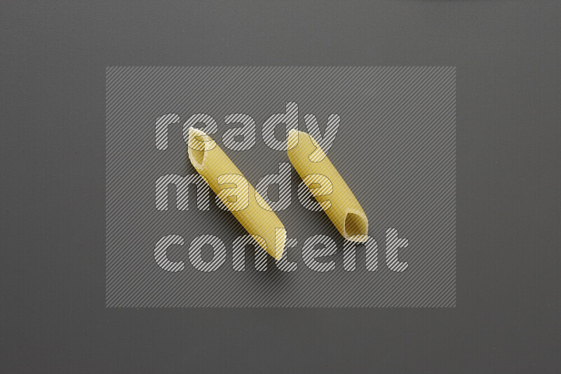 Penne pasta on grey background