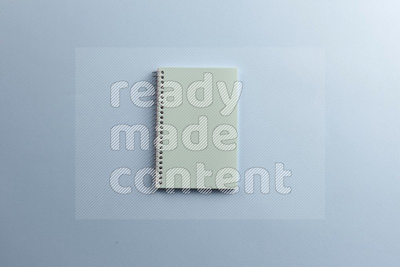 A blue notebook on blue background (Back to school)