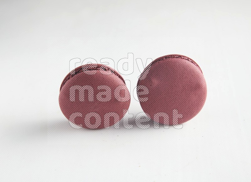 45º Shot of two Red Cherry macarons on white background