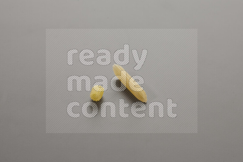 Small rings pasta with other types of pasta on grey background