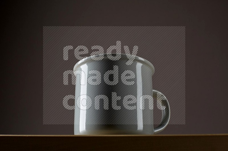 Low angle shot of a grey cup on grey background