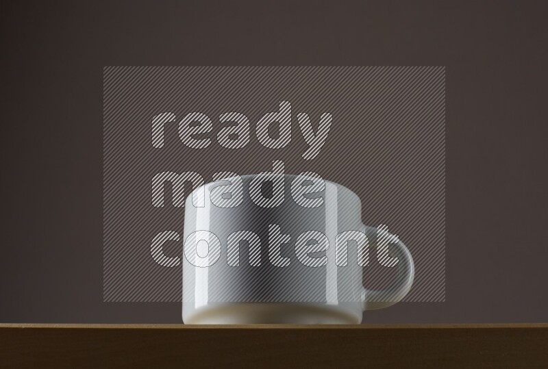 Low angle shot of a white cup on grey background
