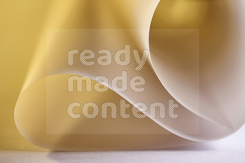 An abstract art piece displaying smooth curves in gold gradients created by colored light