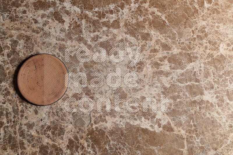 Top View Shot Of A Pottery Coaster On beige Marble Flooring