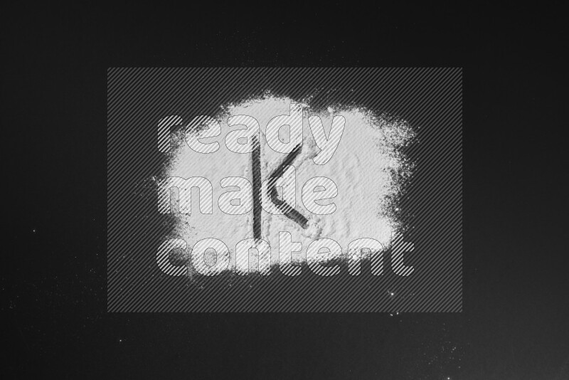 Alphabets written with powder on black background