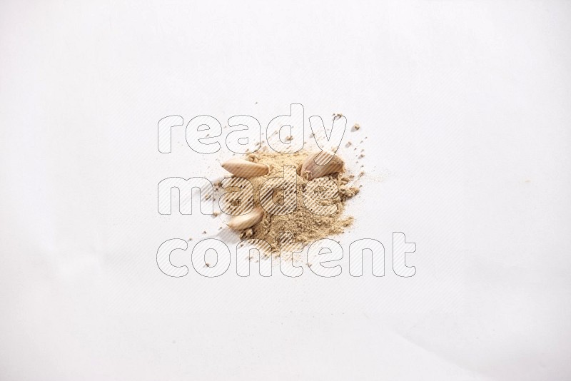 A small pile of garlic powder with some of cloves and a whole garlic bulb on a white flooring