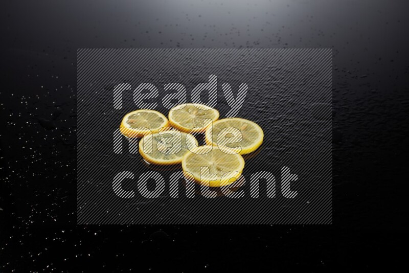 Lemon slices with water drops, and droplets on black background