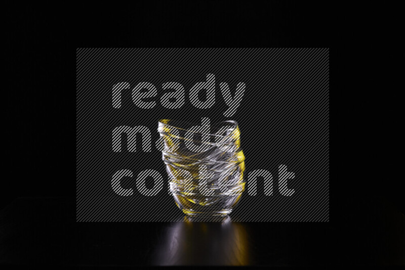 Glassware with rim light in yellow and white against black background