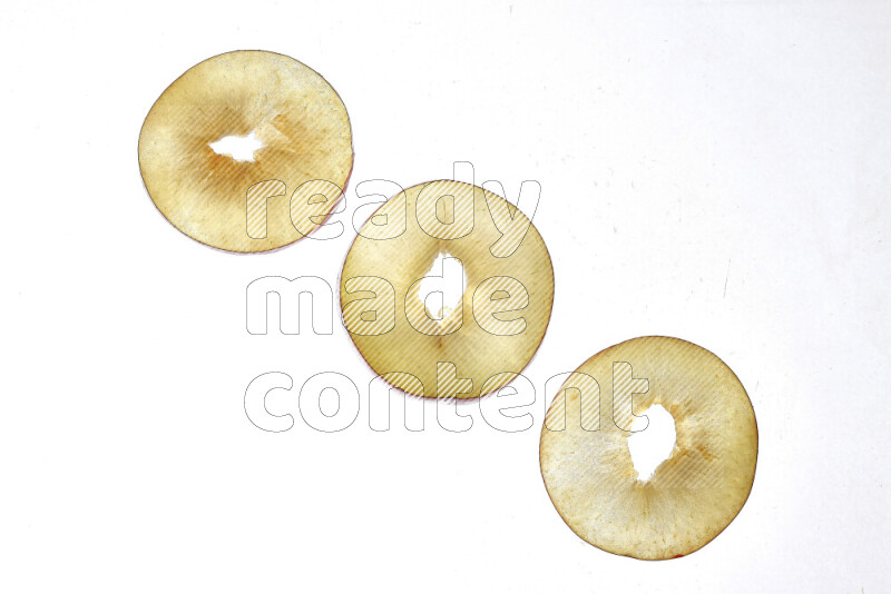 Peach slices on illuminated white background