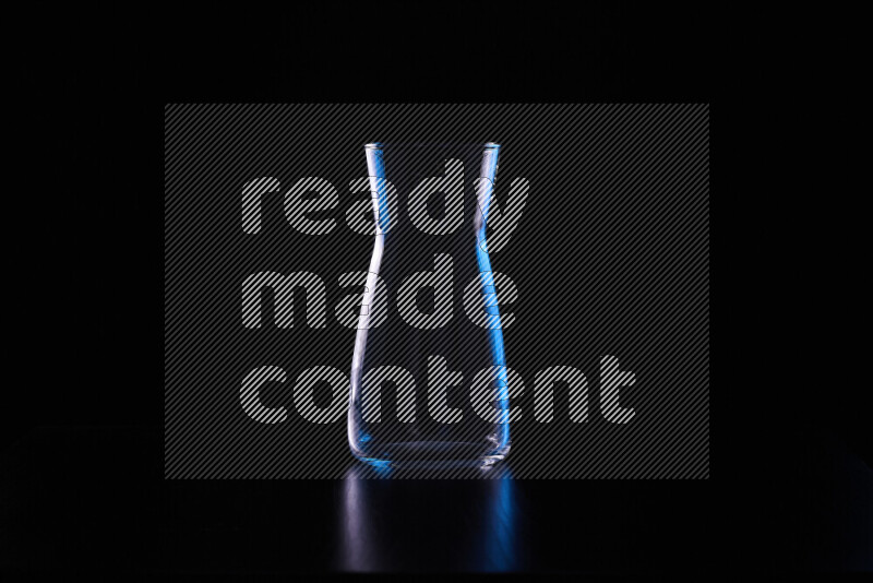 Glassware with rim light in blue and white against black background