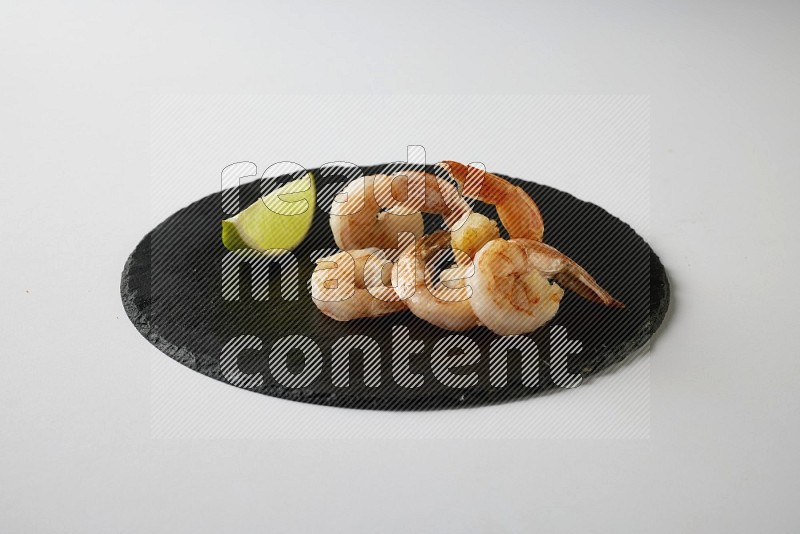 five grilled shrimps  on a black slate direct  on a white back ground