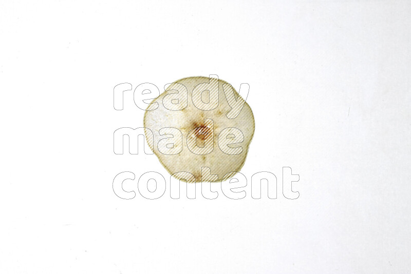 Pear slices on illuminated white background