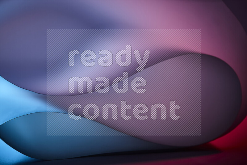 فن تجريدي يعرض منحنيات وتدرجات اللون الأزرق والأحمر مكونه بضوء ملون