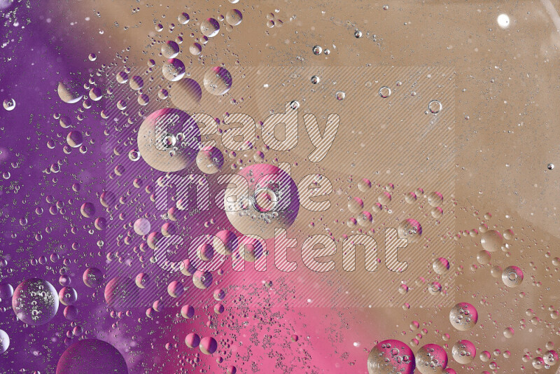 Close-ups of abstract oil bubbles on water surface in shades of brown, purple and pink