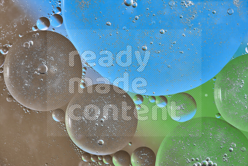 Close-ups of abstract oil bubbles on water surface in shades of brown, green and blue