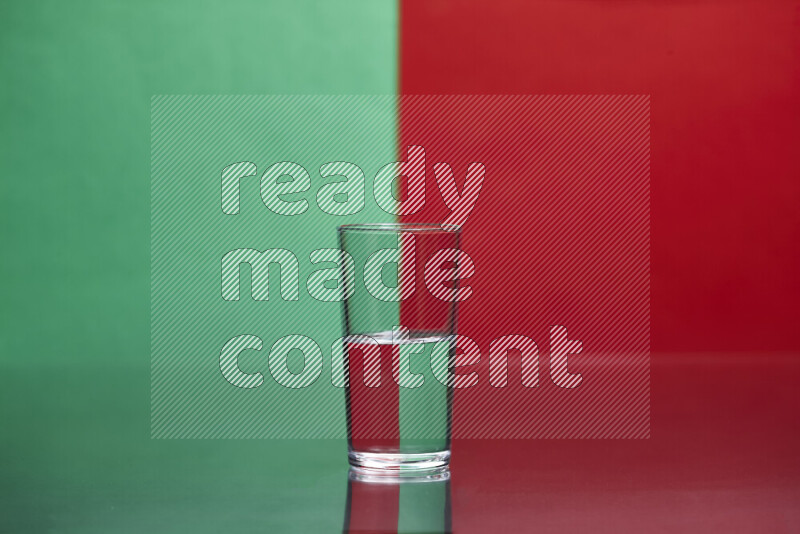 The image features a clear glassware filled with water, set against green and red background