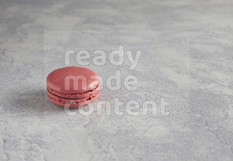 45º Shot of Pink Raspberry macaron on white  marble background