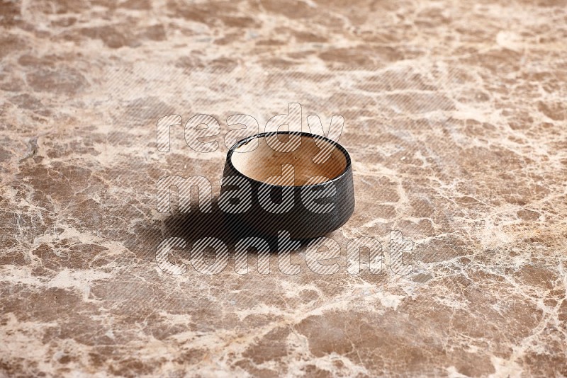 Black Pottery Bowl on Beige Marble Flooring, 45 degrees