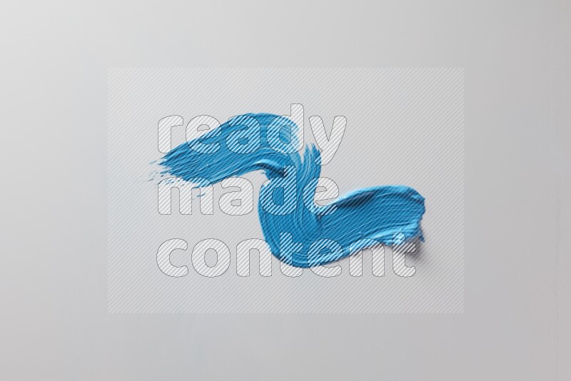 A single blue S curved brush stroke on a white background