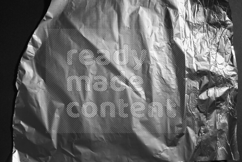 Aluminium foil on black background
