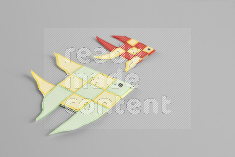 Origami fish on grey background