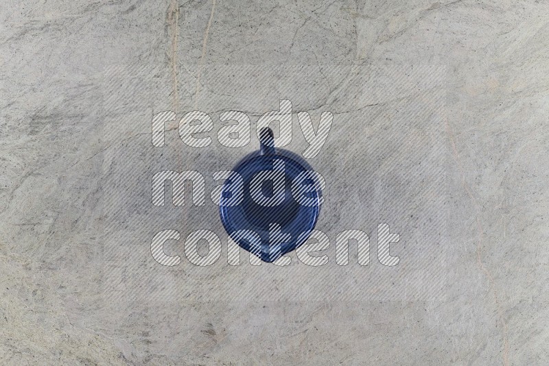 Top View Shot Of An Empty Glass Jug On Grey Marble Flooring