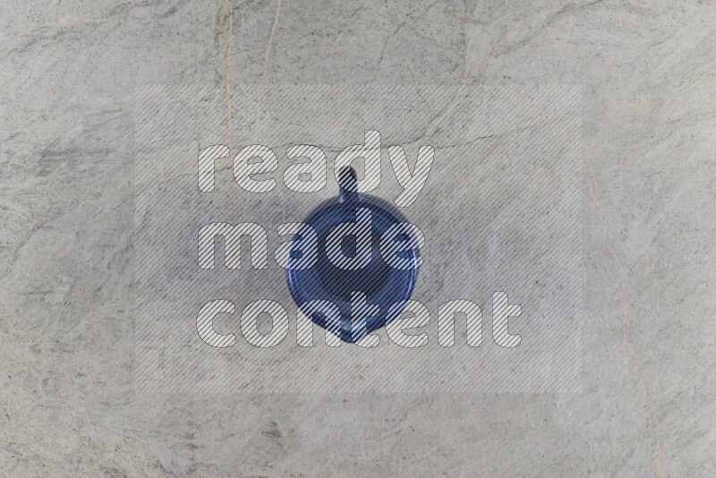 A colored glass jug on grey marble background