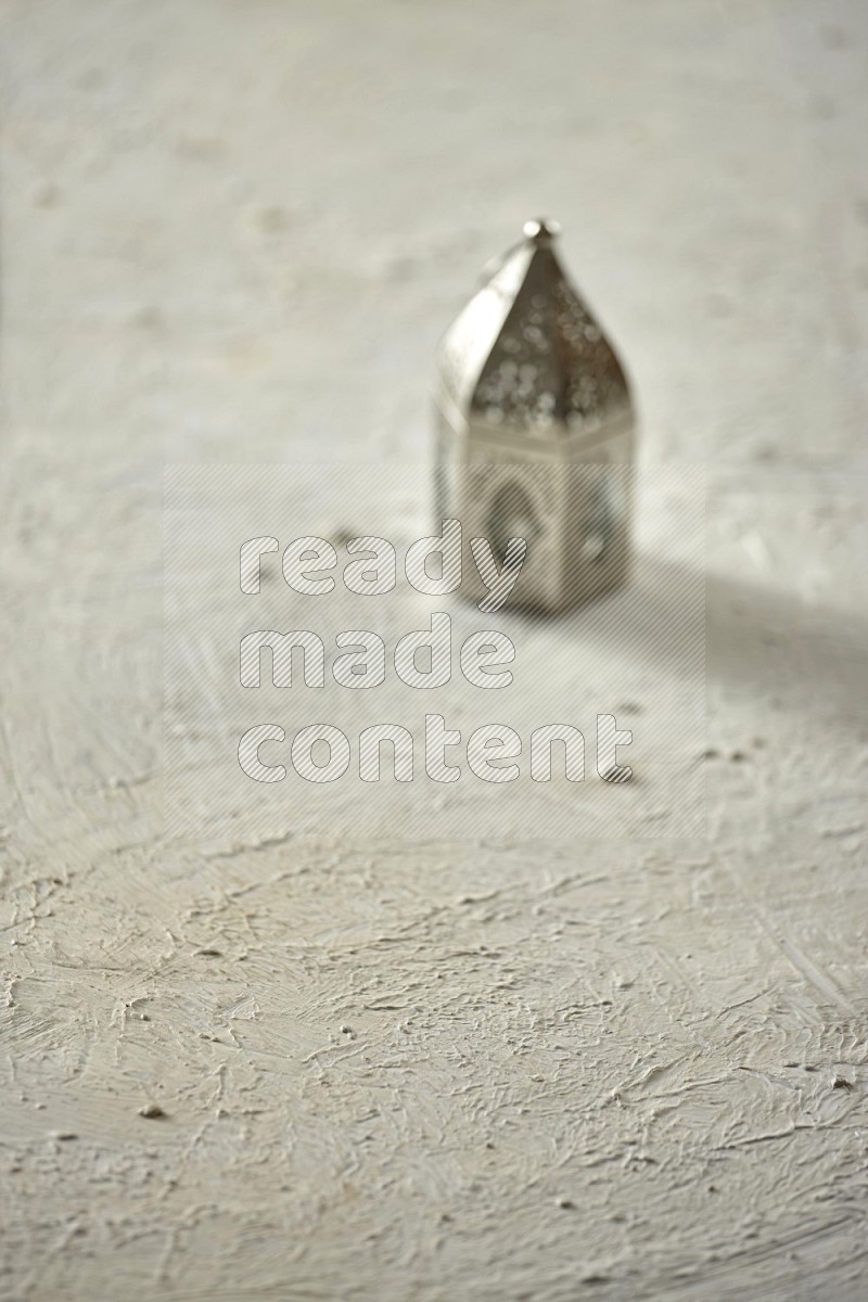 An out of focus lantern on textured white background