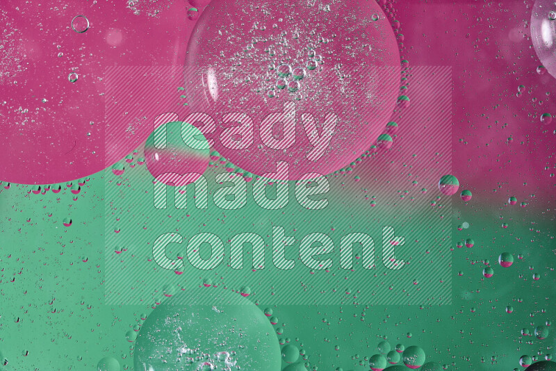 Close-ups of abstract oil bubbles on water surface in shades of green and pink
