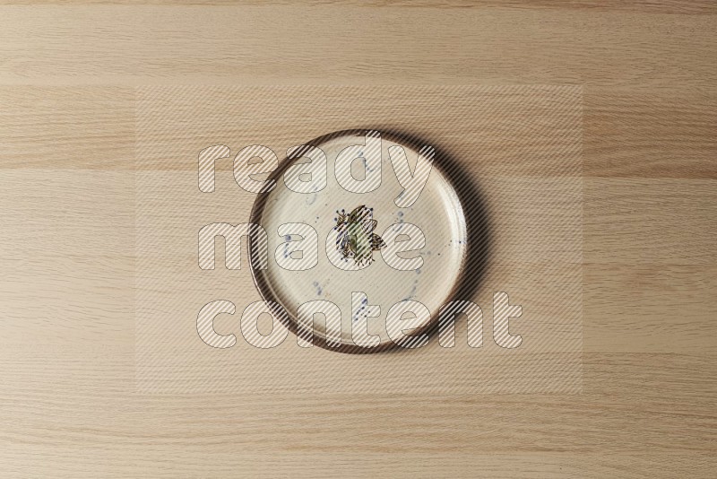 Top View Shot Of A Decorative Pottery Plate on Oak Wooden Flooring