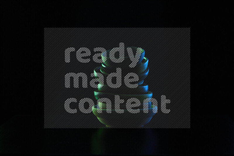 Wooden kitchen essentials with colored rim light against black background