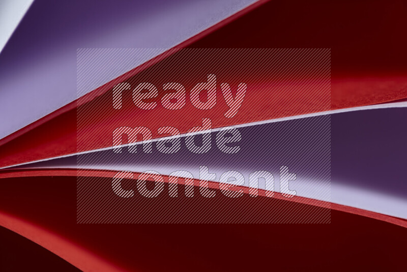 An abstract art showing purple and red paper sheets arranged in an overlapping curves