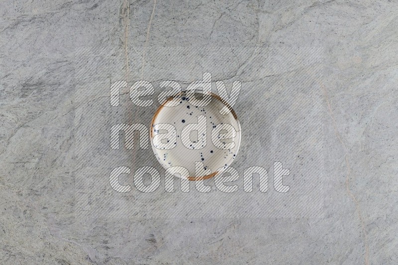 Top View Shot Of A Multicolored Pottery Bowl On Grey Marble Flooring