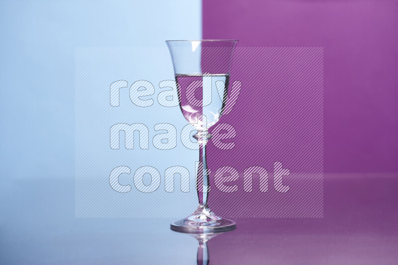 The image features a clear glassware filled with water, set against light blue and purple background