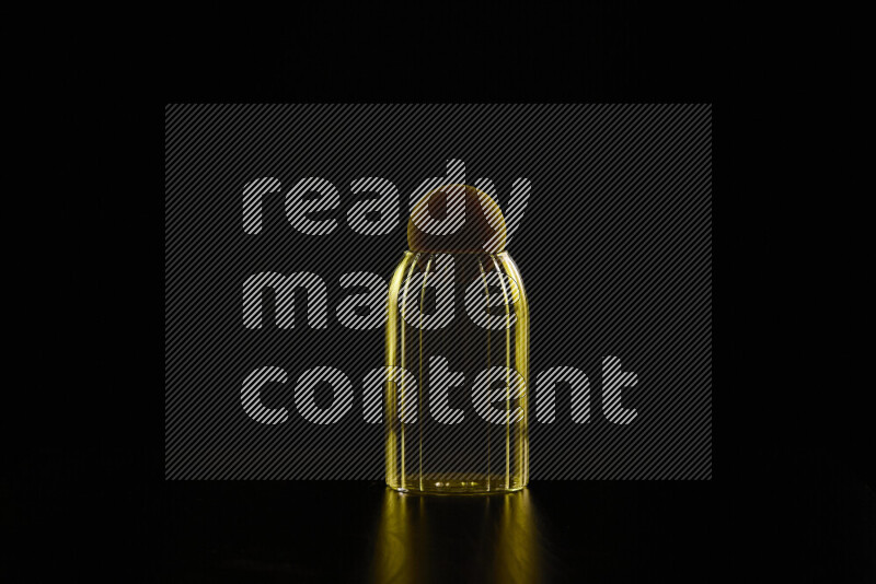 Glassware with rim light in yellow against black background