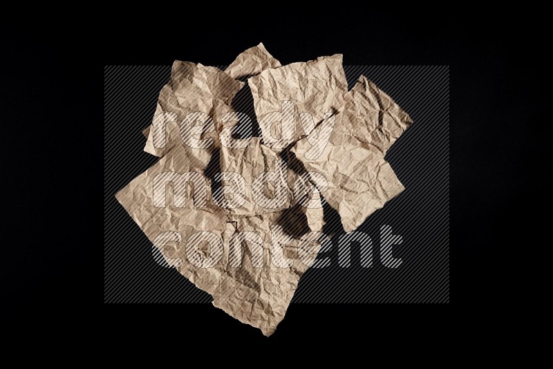 Crumpled craft paper on black background