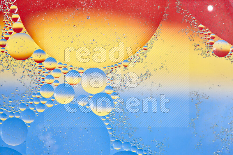 Close-ups of abstract oil bubbles on water surface in shades of yellow, red and blue