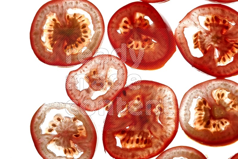 Tomatoes slices on illuminated white background