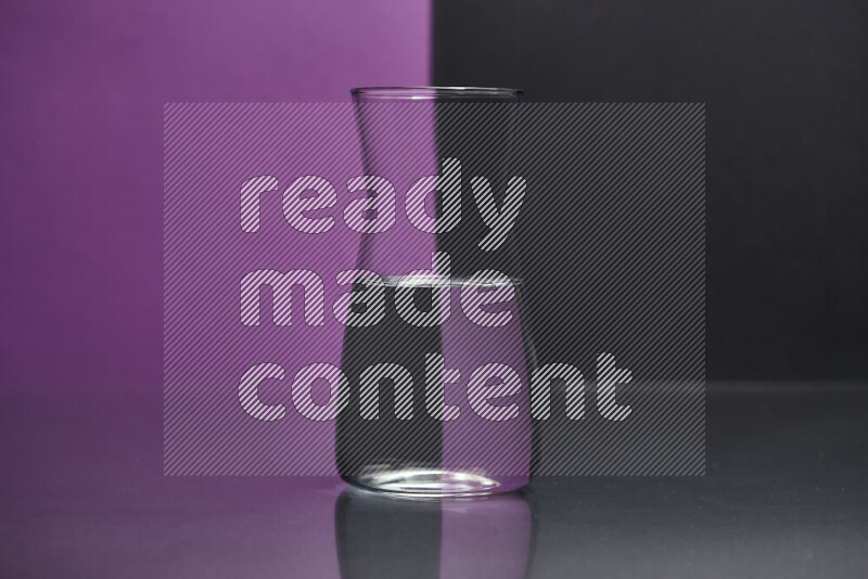 The image features a clear glassware filled with water, set against purple and black background