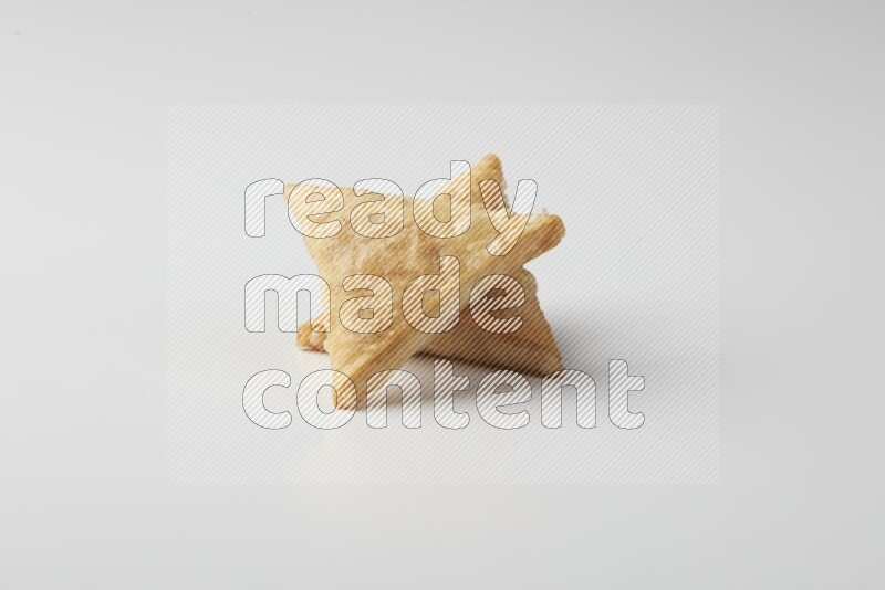 Two fried sambosas on a white background