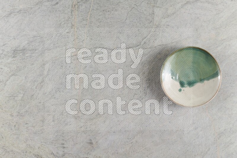 A multicolored pottery Bowl on grey marble background
