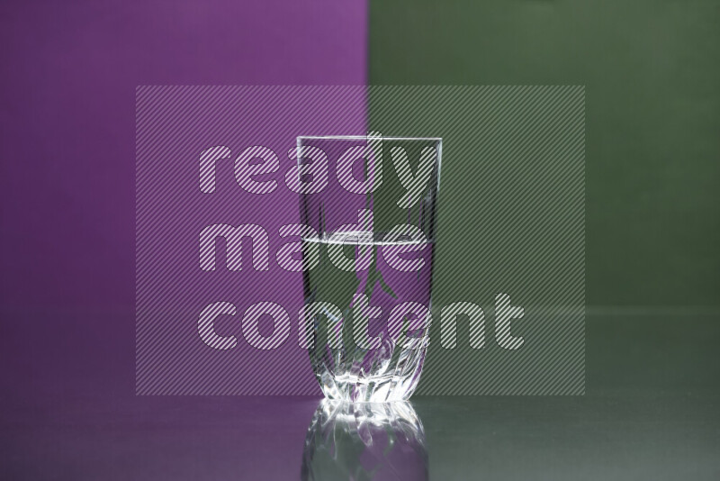 The image features a clear glassware filled with water, set against purple and dark green background