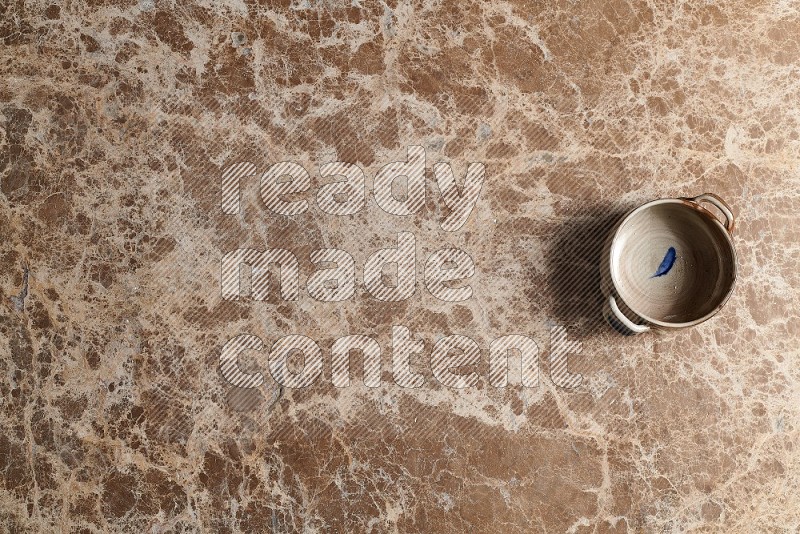 Top View Shot Of A Multicolored Pottery bowl On beige Marble Flooring