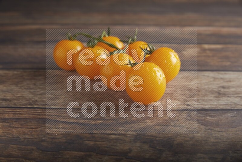 yellow cherry tomato vein on a textured wooden background 45 degree