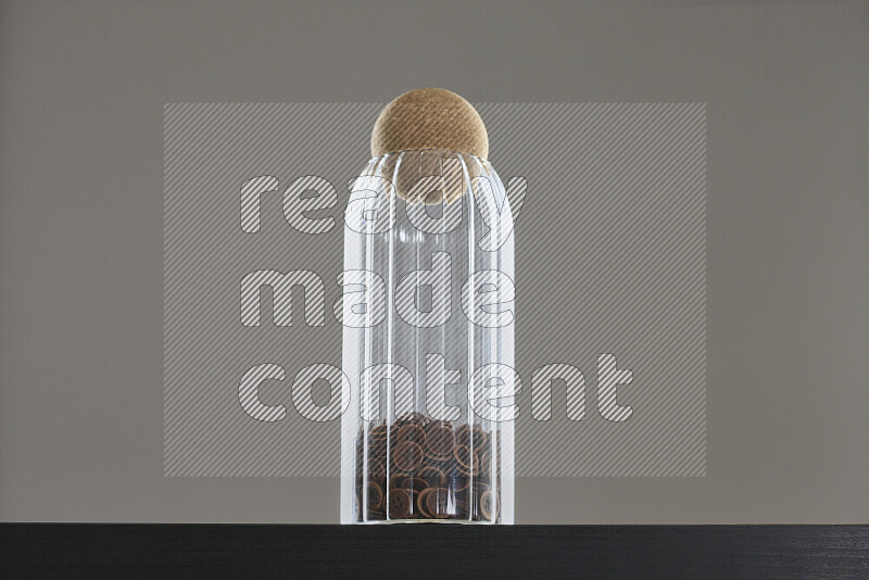 Buttons in a glass jar on black background